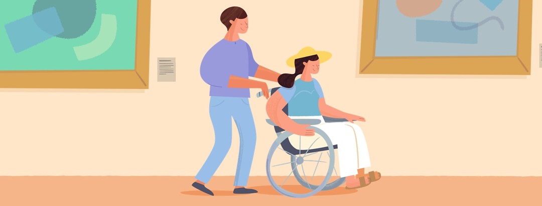 Woman in a wheelchair being pushed through a museum by her friend